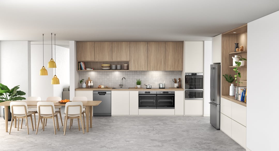 Two ovens built into kitchen cabinetry with a dining table and chairs