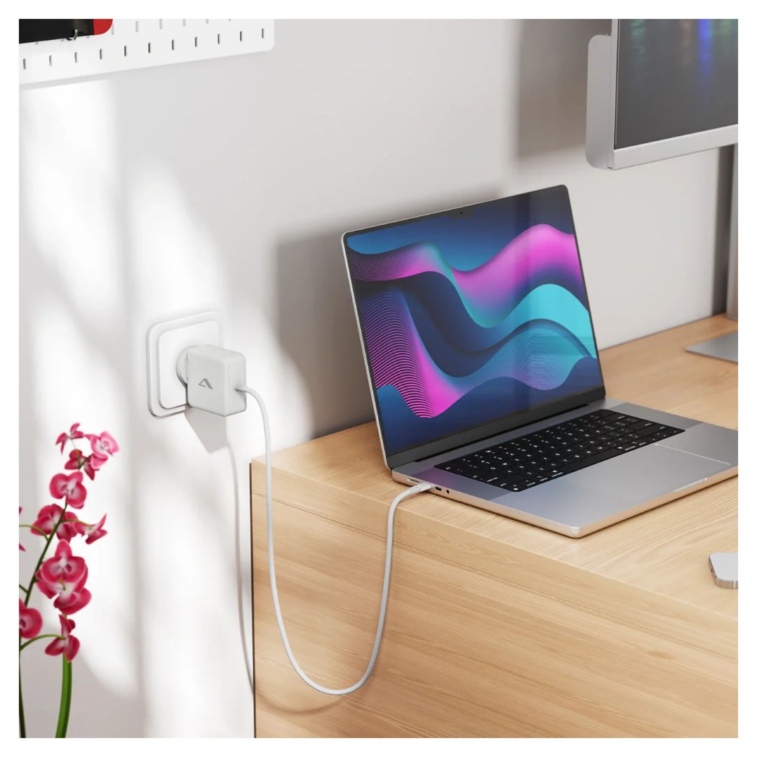 ALOGIC Rapid Power 65W GaN Charger plugged into wall, charging laptop
