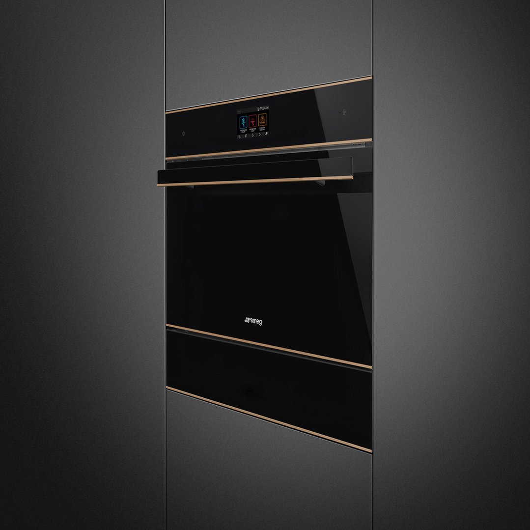 Built-in blast chiller with black glass and copper trim in a dark kitchen