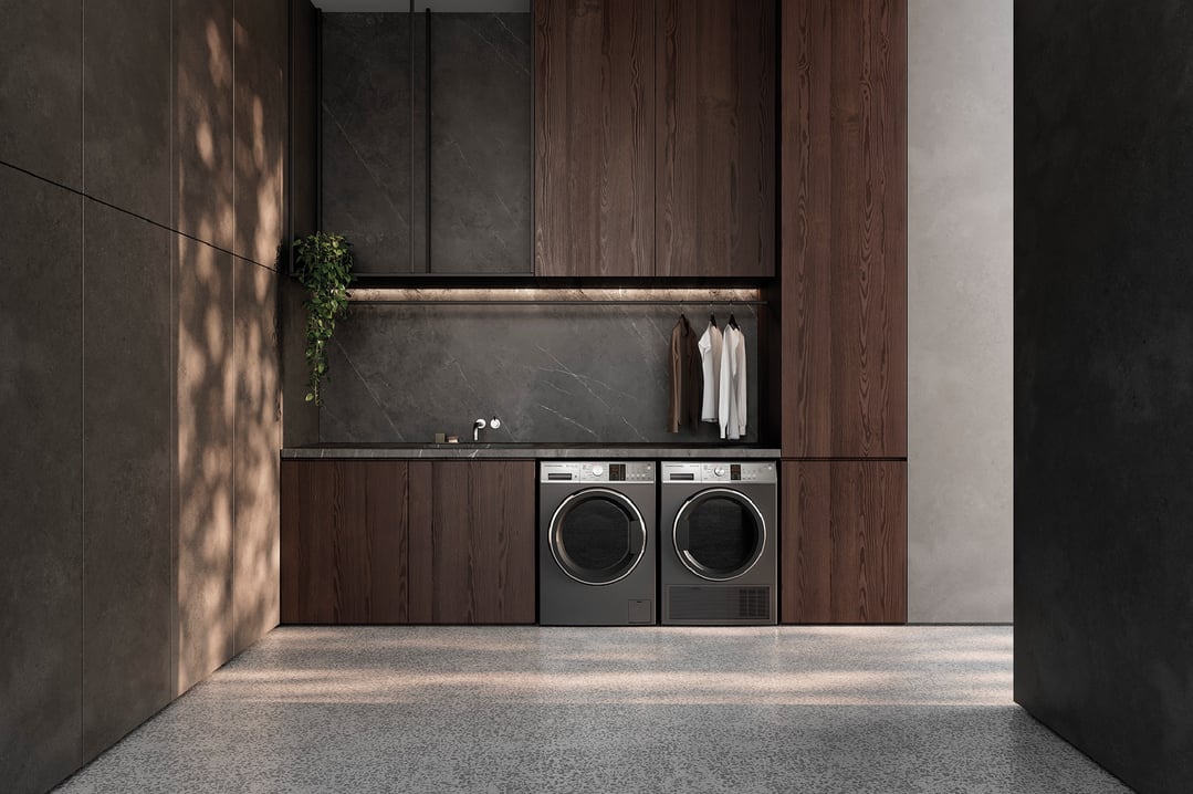 Two Fisher & Paykel washing machines in a modern laundry with dark wood cabinetry