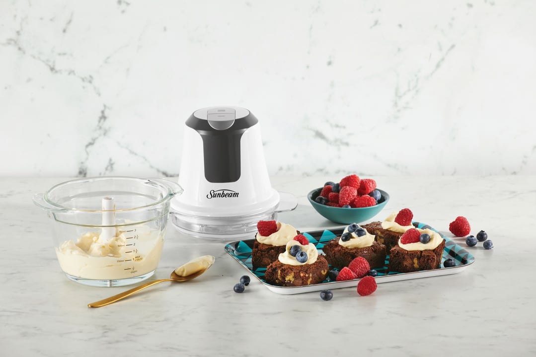 Sunbeam Mini Glass MultiChopper on a marble counter with brownies and berries
