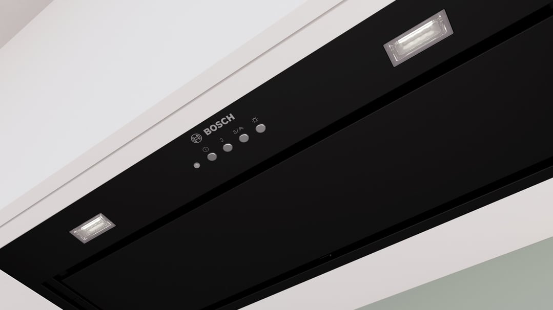 Close-up of a black Bosch integrated rangehood with controls and lights