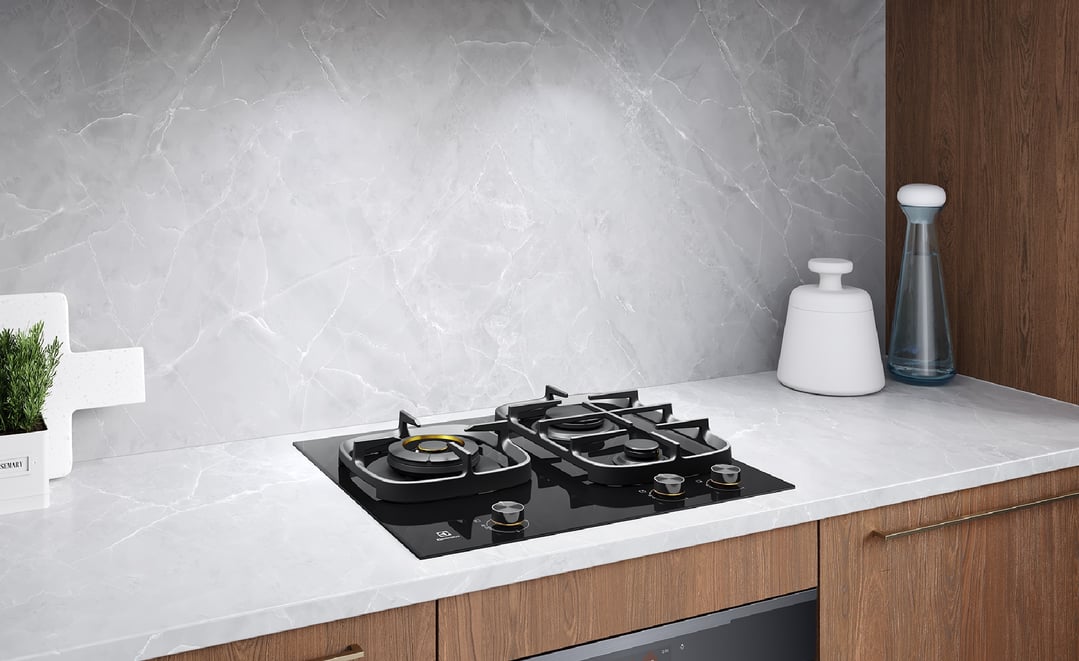 Black ceramic glass 3 burner gas cooktop built into a modern kitchen counter