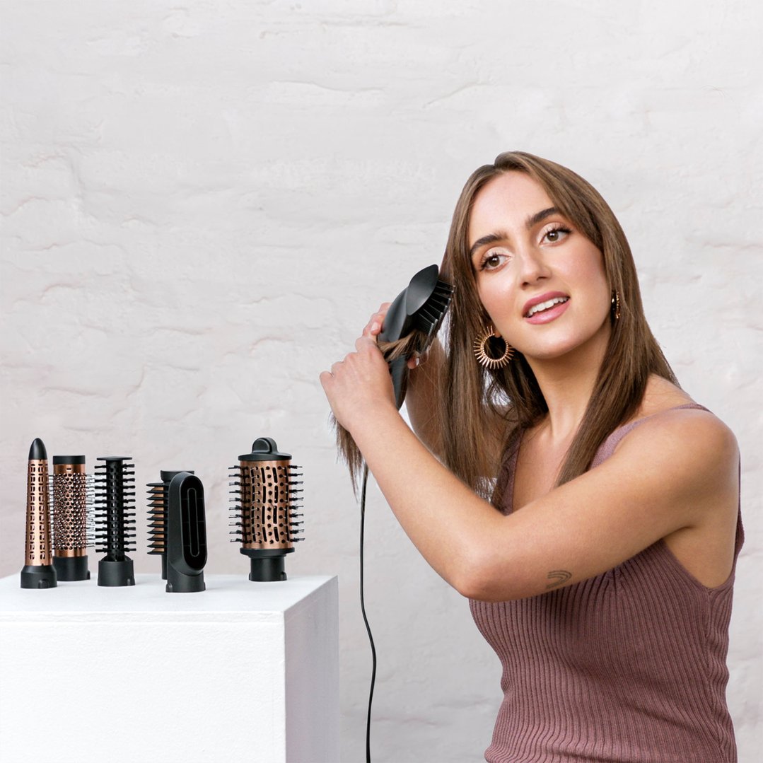 Woman styling her hair with the Air Style Brilliance 7-in-1 hair styler