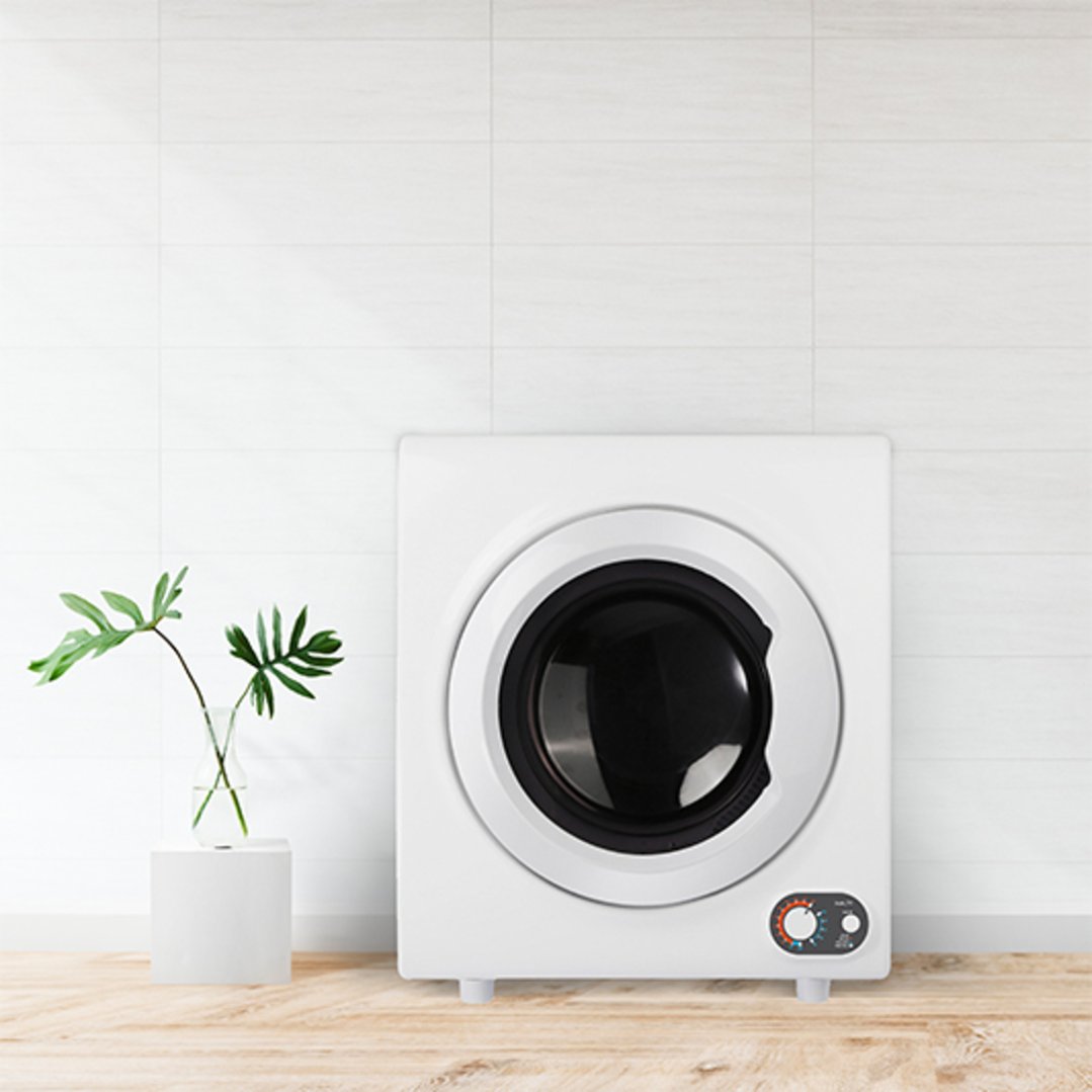 White vented dryer on a wooden surface with a plant in a vase