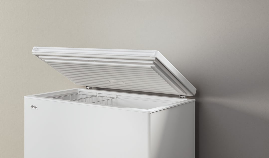 White Haier chest freezer with the lid open in a room