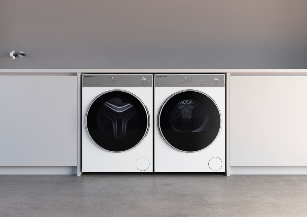 Two white Fisher & Paykel dryers installed side-by-side in a modern laundry