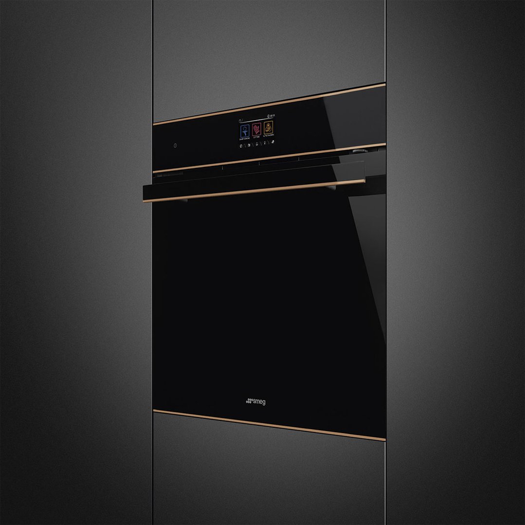 Black and copper trim oven built into dark cabinetry in a kitchen