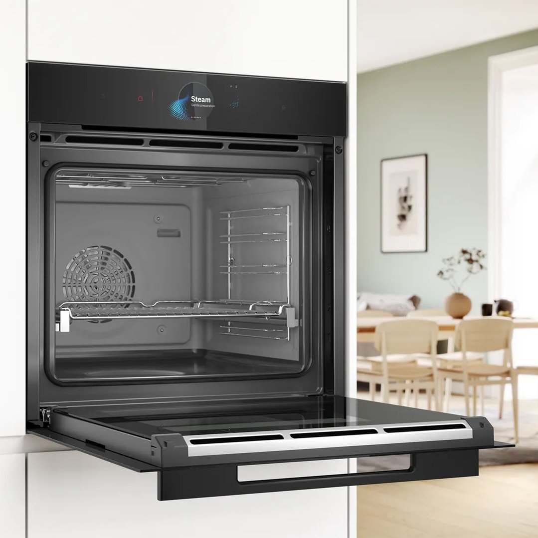 Built-in oven with steam function, door open, in a modern kitchen setting