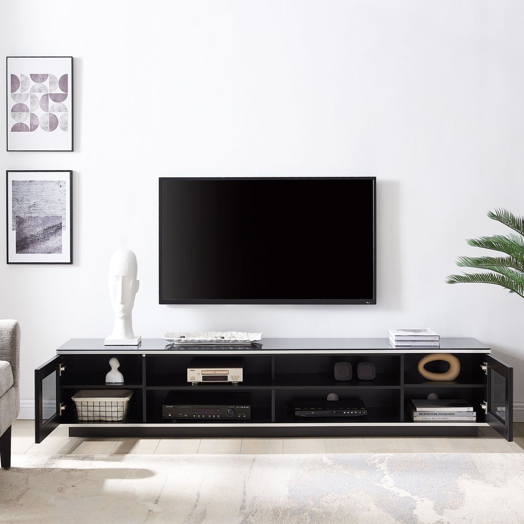 Black TV cabinet with a TV and decor in a modern living room