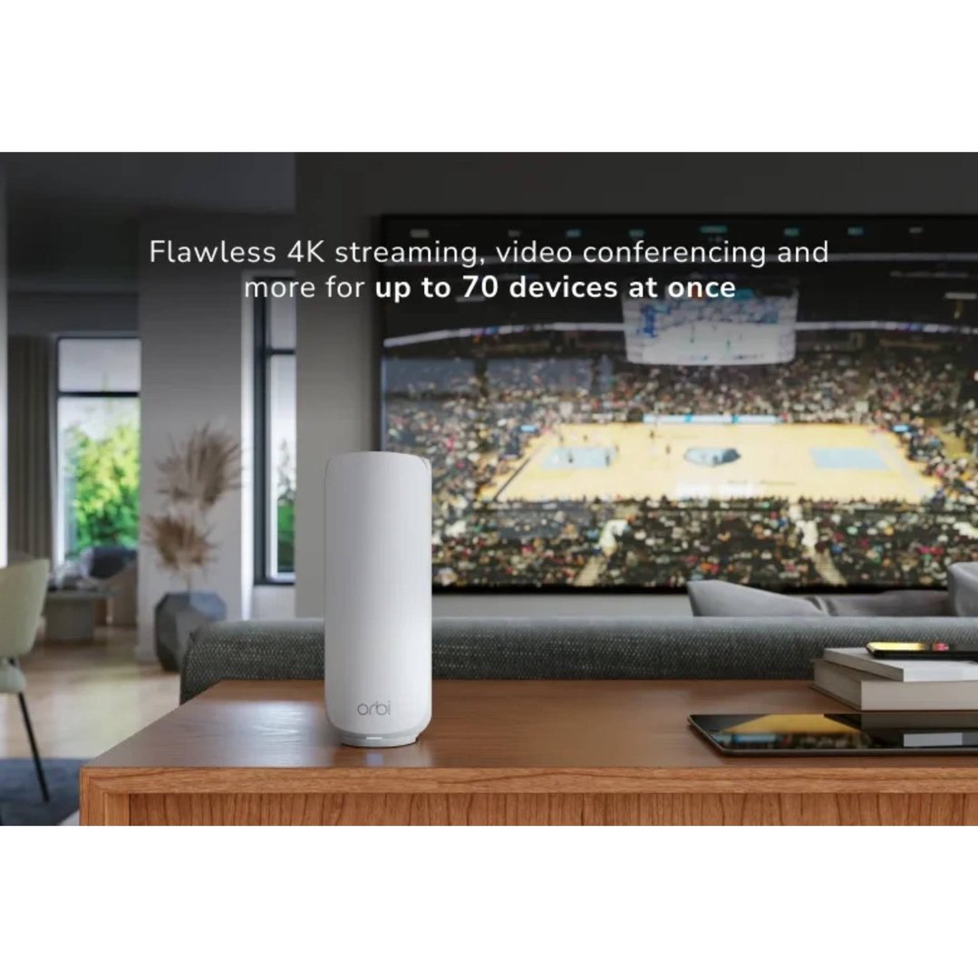 White Orbi mesh router on a wooden table in a living room