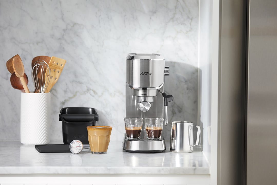 Sunbeam Compact Barista Espresso Machine on a marble kitchen counter with accessories