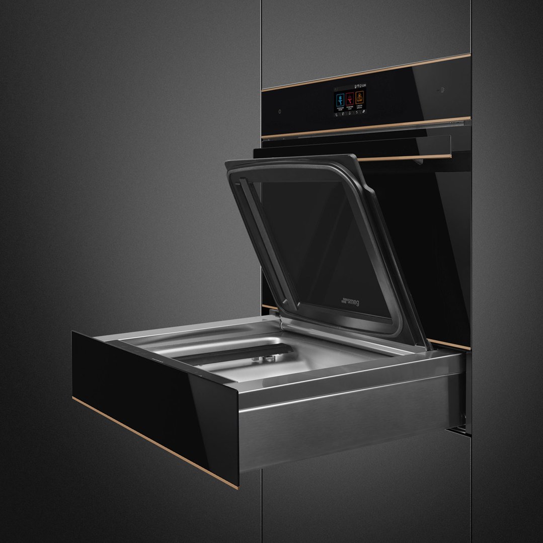 Black blast chiller with open door and pull-out drawer in a dark kitchen
