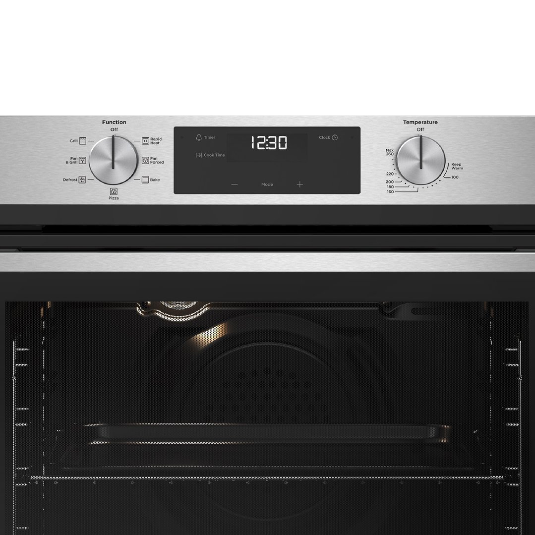 Close up of a stainless steel oven's control panel and interior