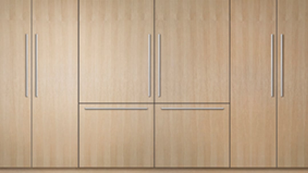 Integrated refrigerator freezer with light wood panels and stainless steel handles