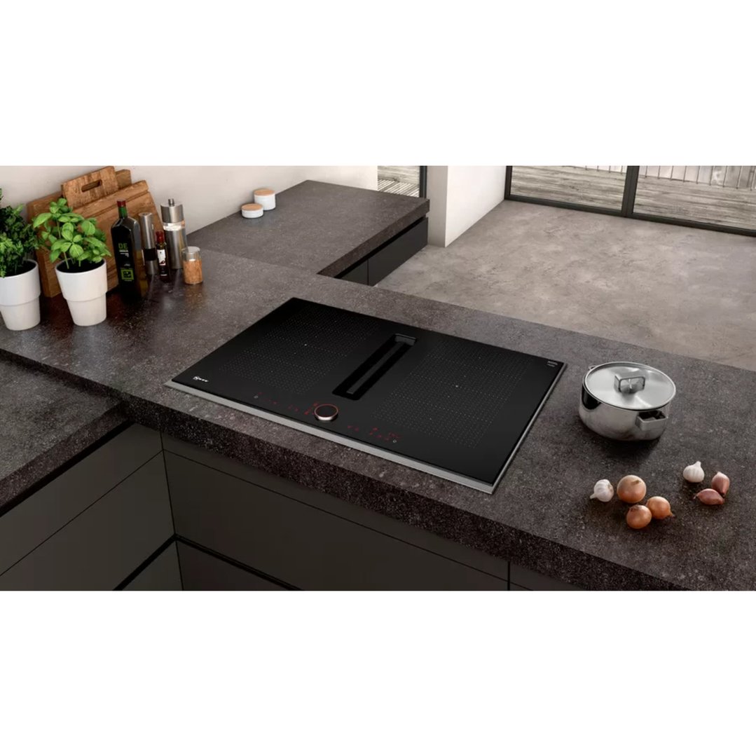 Induction hob with integrated ventilation system in a modern kitchen setting