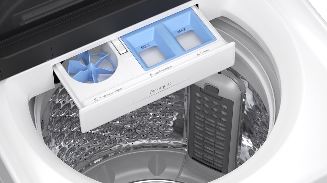 Close up of the detergent dispenser and drum inside a top load washing machine