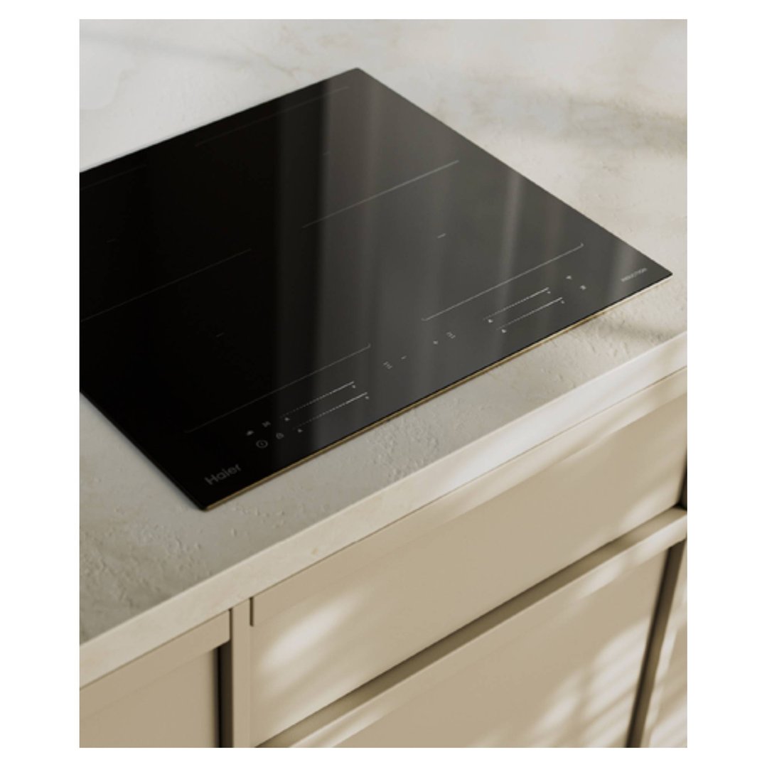 Haier induction cooktop built into a light-colored kitchen countertop