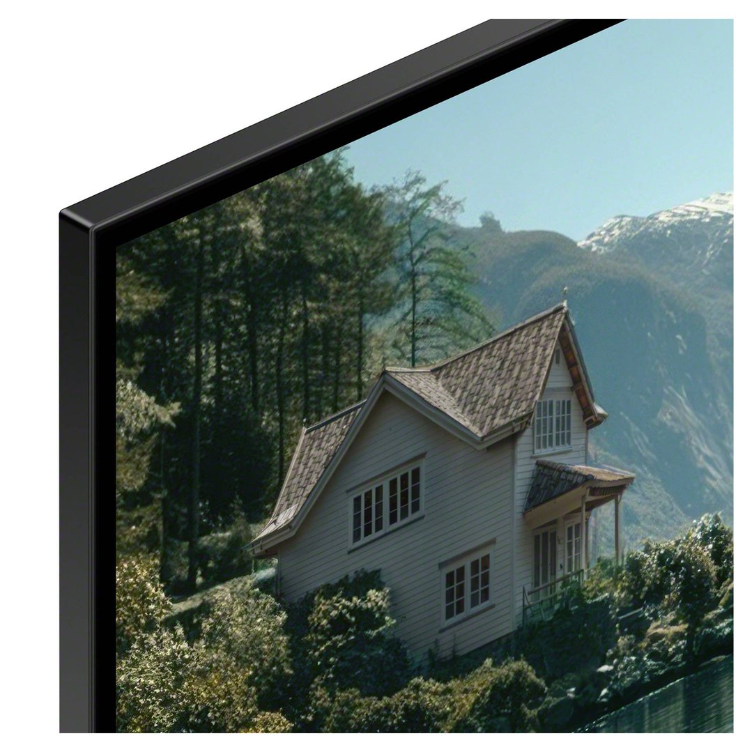 Close-up of a SONY TV displaying a house in a mountainous, forested landscape