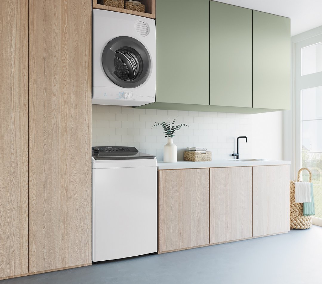 A white top load washing machine and dryer in a modern laundry room
