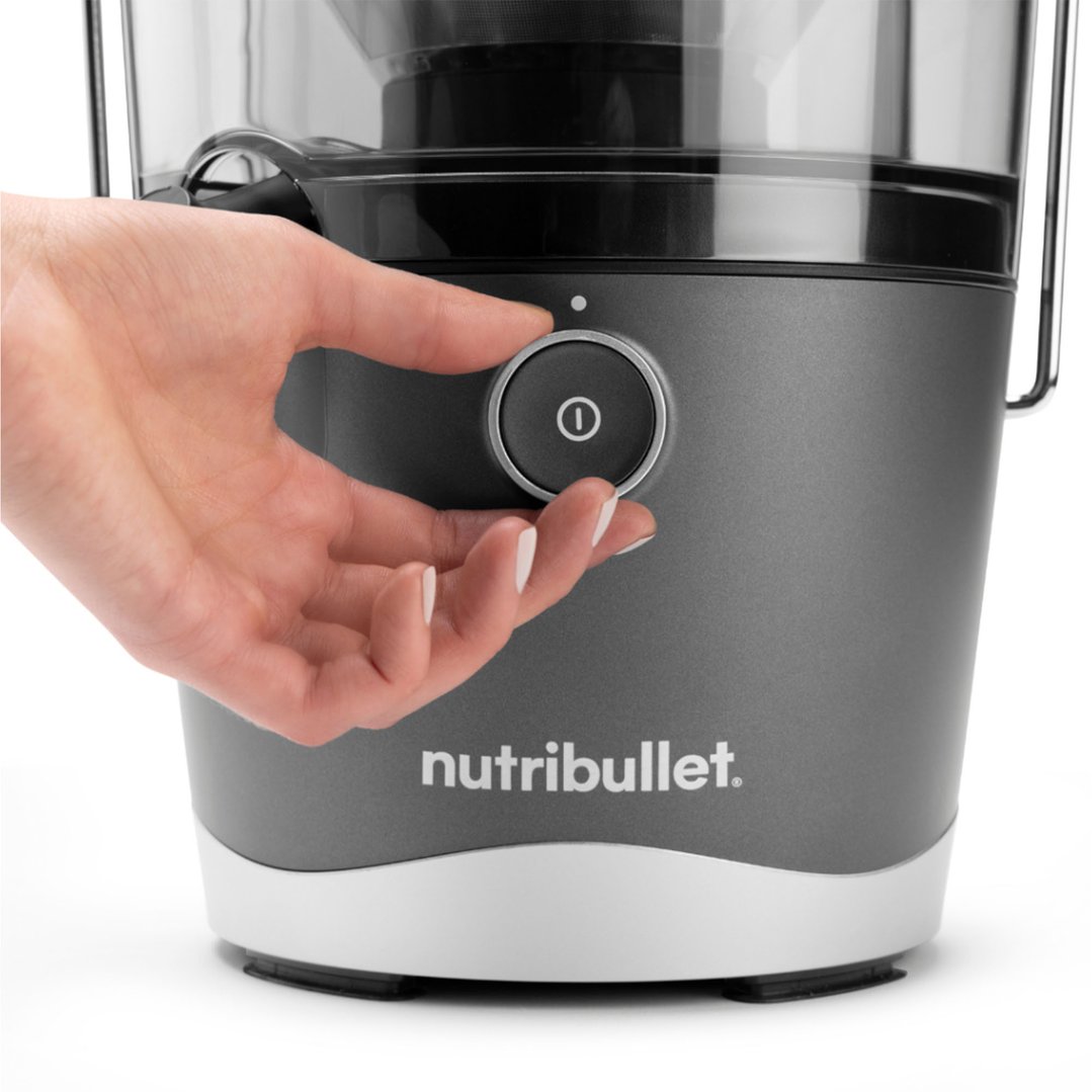 Hand adjusting the control dial on a Nutribullet juicer