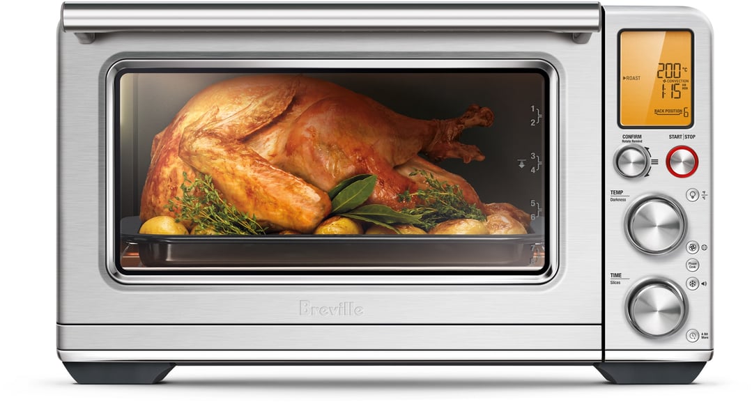 Breville Smart Oven Air Fryer XL roasting a turkey with herbs and lemons