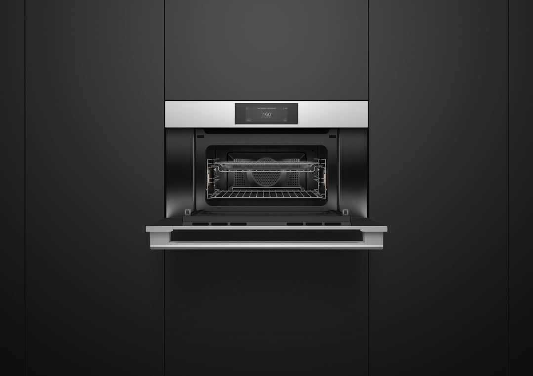 Open microwave oven with a digital display showing 160 degrees in a dark kitchen