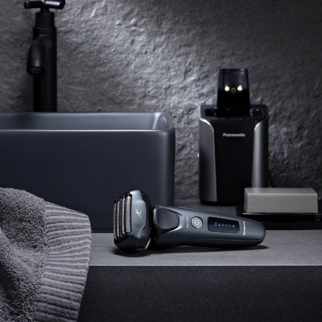 Panasonic Multi-Flex 5-Blade Rechargeable Shaver on a bathroom counter with accessories