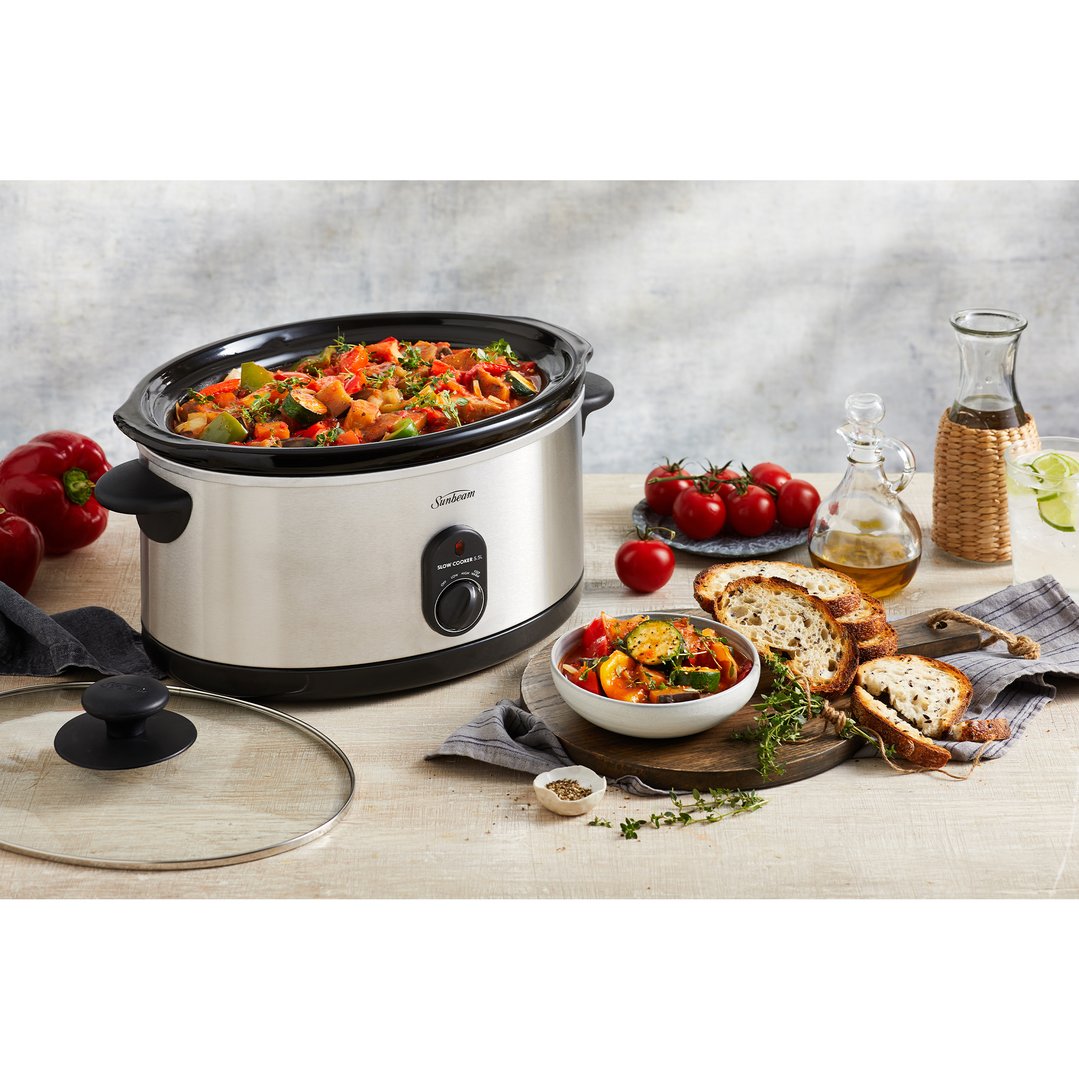 Sunbeam Slow Cooker 5.5L filled with vegetables on a wooden table with food