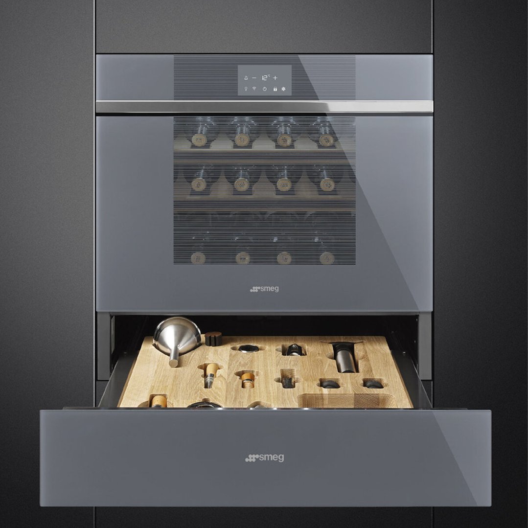 Built-in wine cellar with open accessory drawer, set in a dark kitchen cabinet