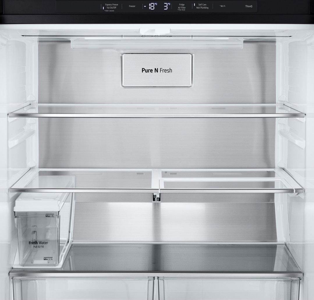 Interior view of a French door fridge with shelves and water dispenser