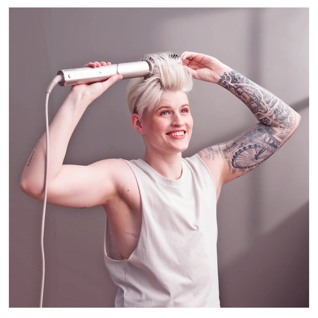 Woman styling her short blonde hair with a Shark FlexStyle Air Styling & Drying System