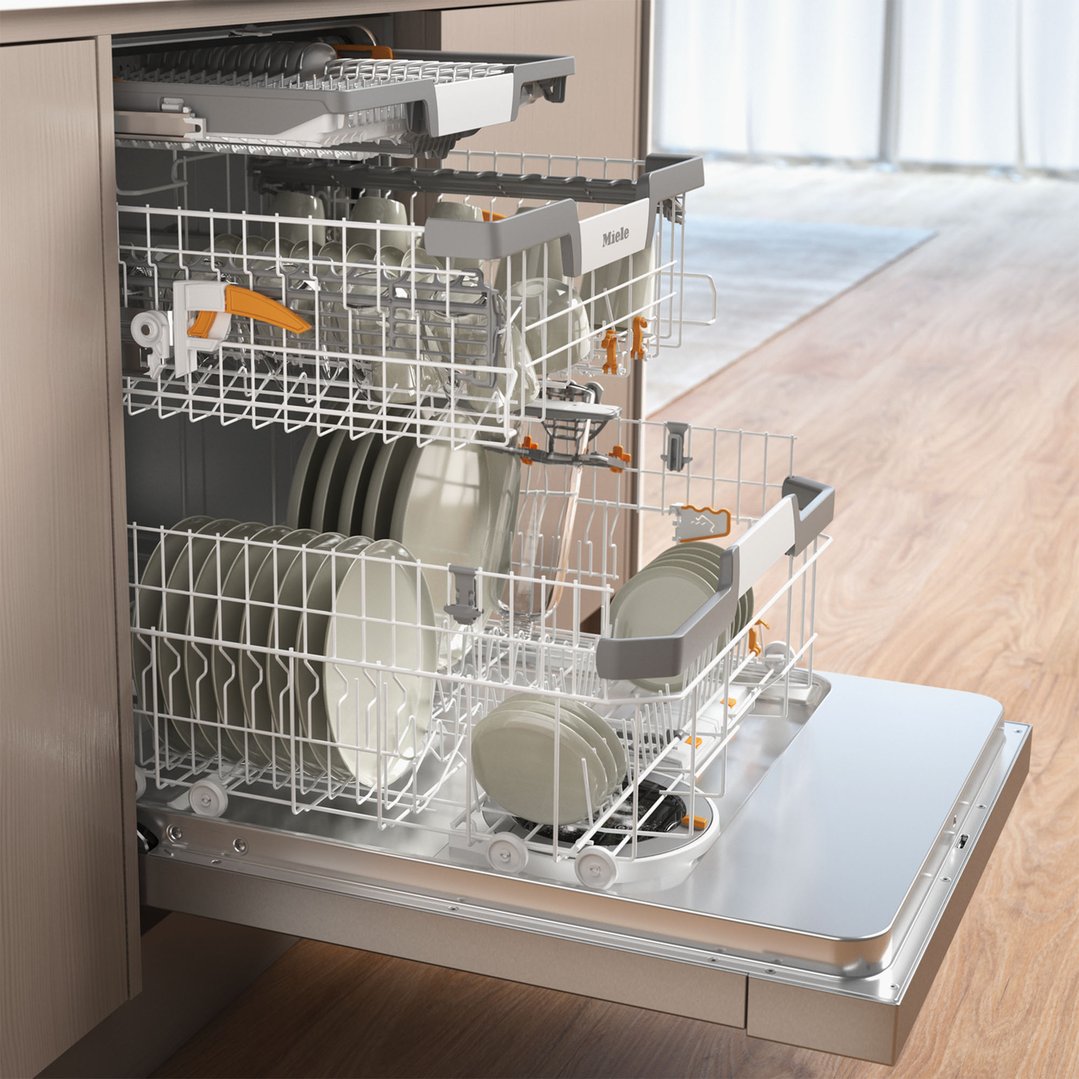 Open dishwasher with racks full of dishes in a kitchen setting