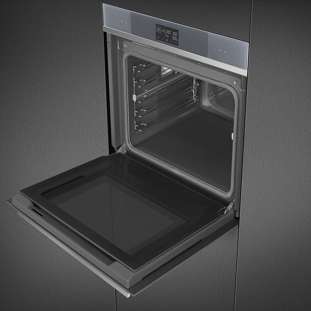 A built-in oven with its door open, showing the interior racks