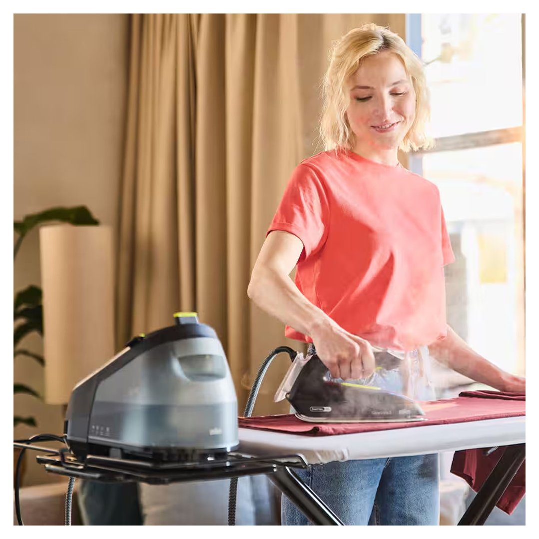 Woman ironing a red garment with a Braun CareStyle 3 Steam Generator Iron