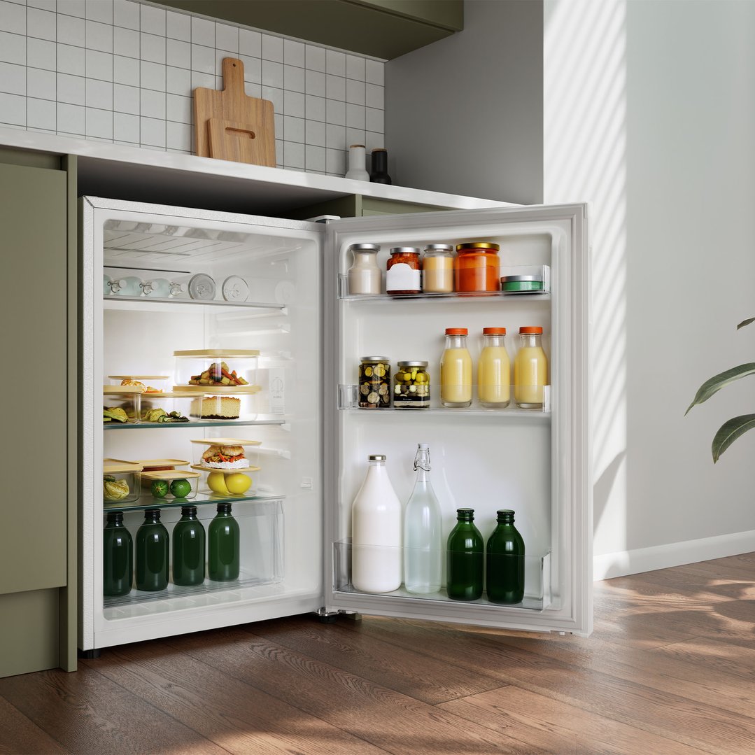 Open bar refrigerator filled with food and drinks in a kitchen setting