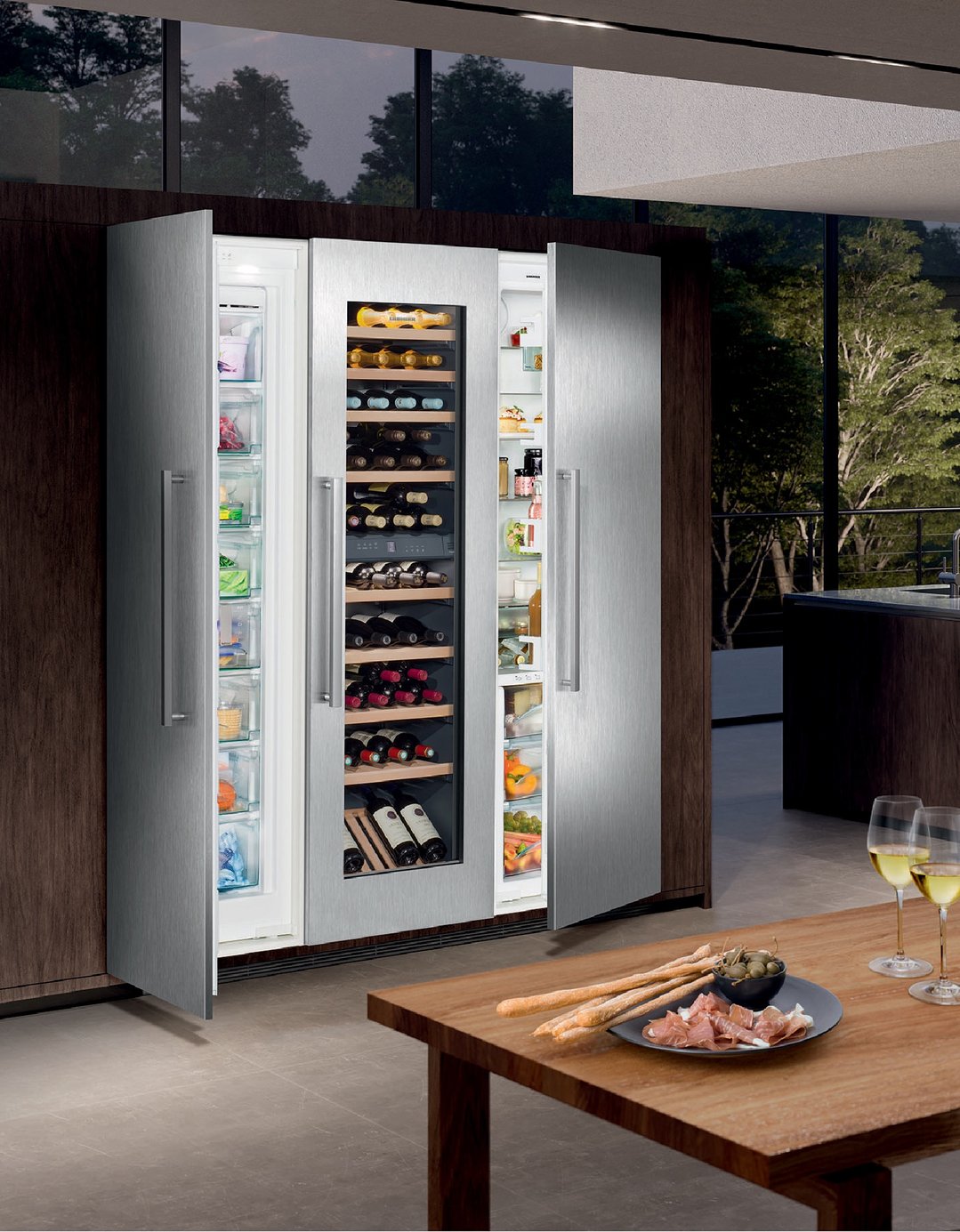Three built-in refrigerators and wine cabinets in a modern kitchen setting