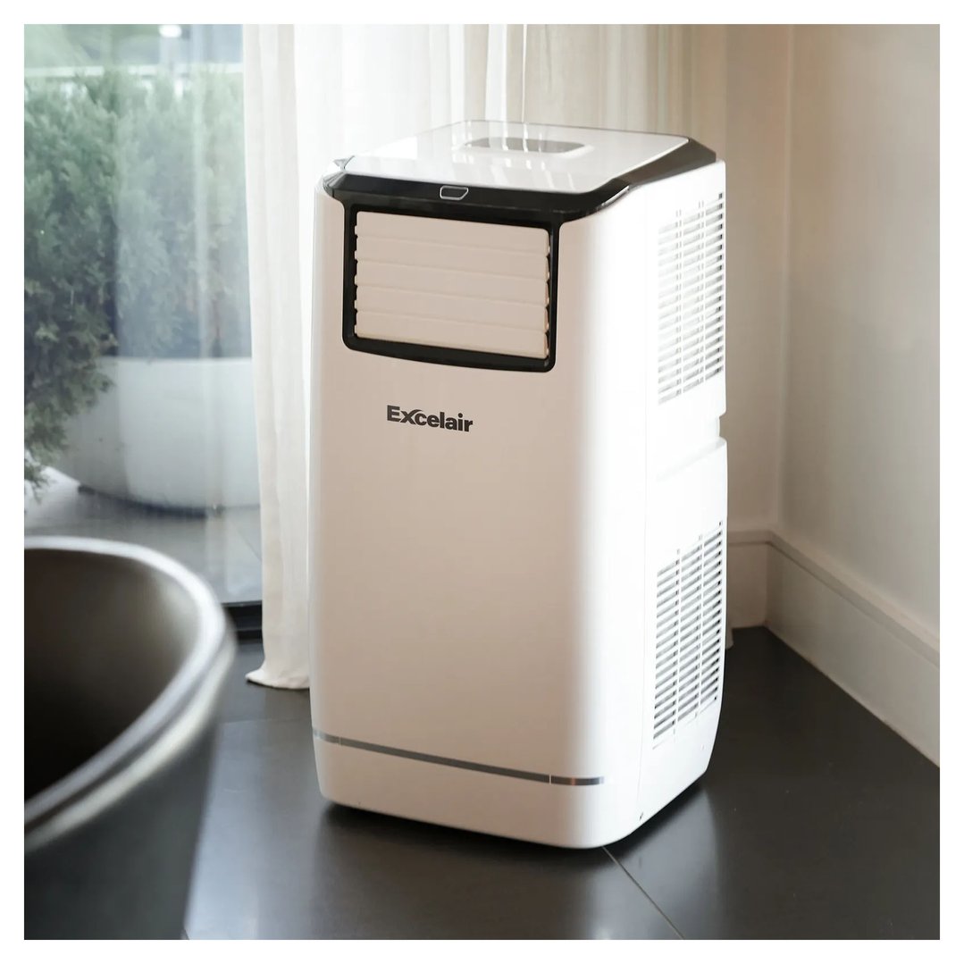 White and black portable air conditioner in a room with a large window
