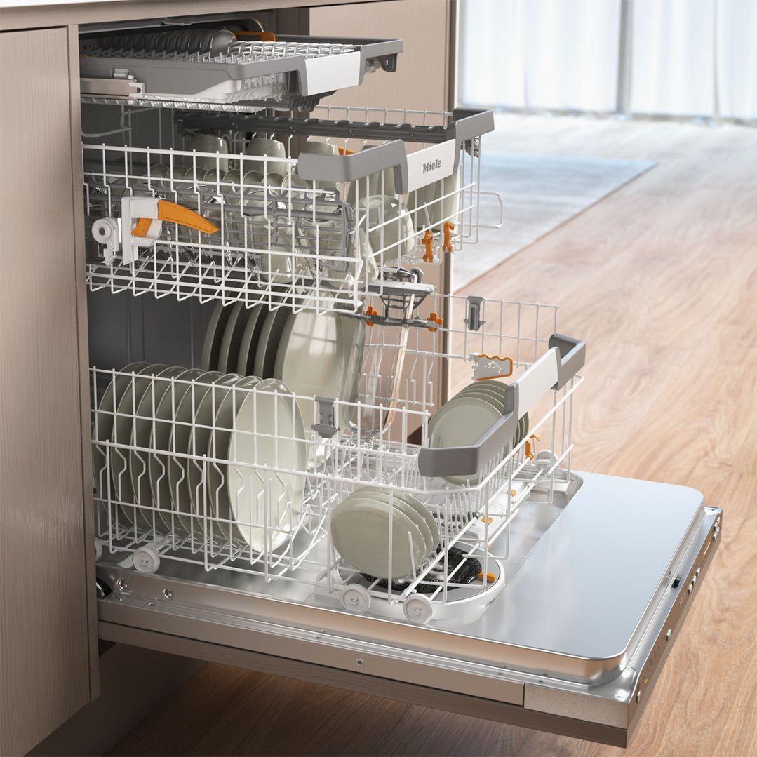 Open dishwasher with racks full of dishes in a kitchen setting
