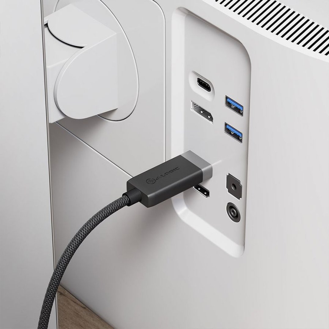 ALOGIC cable connected to a computer monitor with various ports