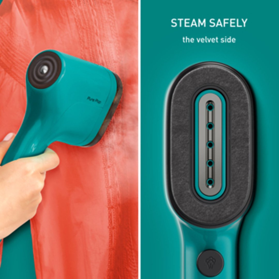 Handheld garment steamer steaming a coral-colored garment, with a close-up of the steamer head