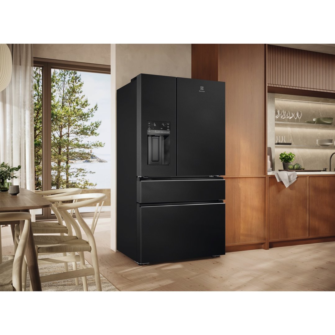 Black French door fridge in a modern kitchen with a view of the sea
