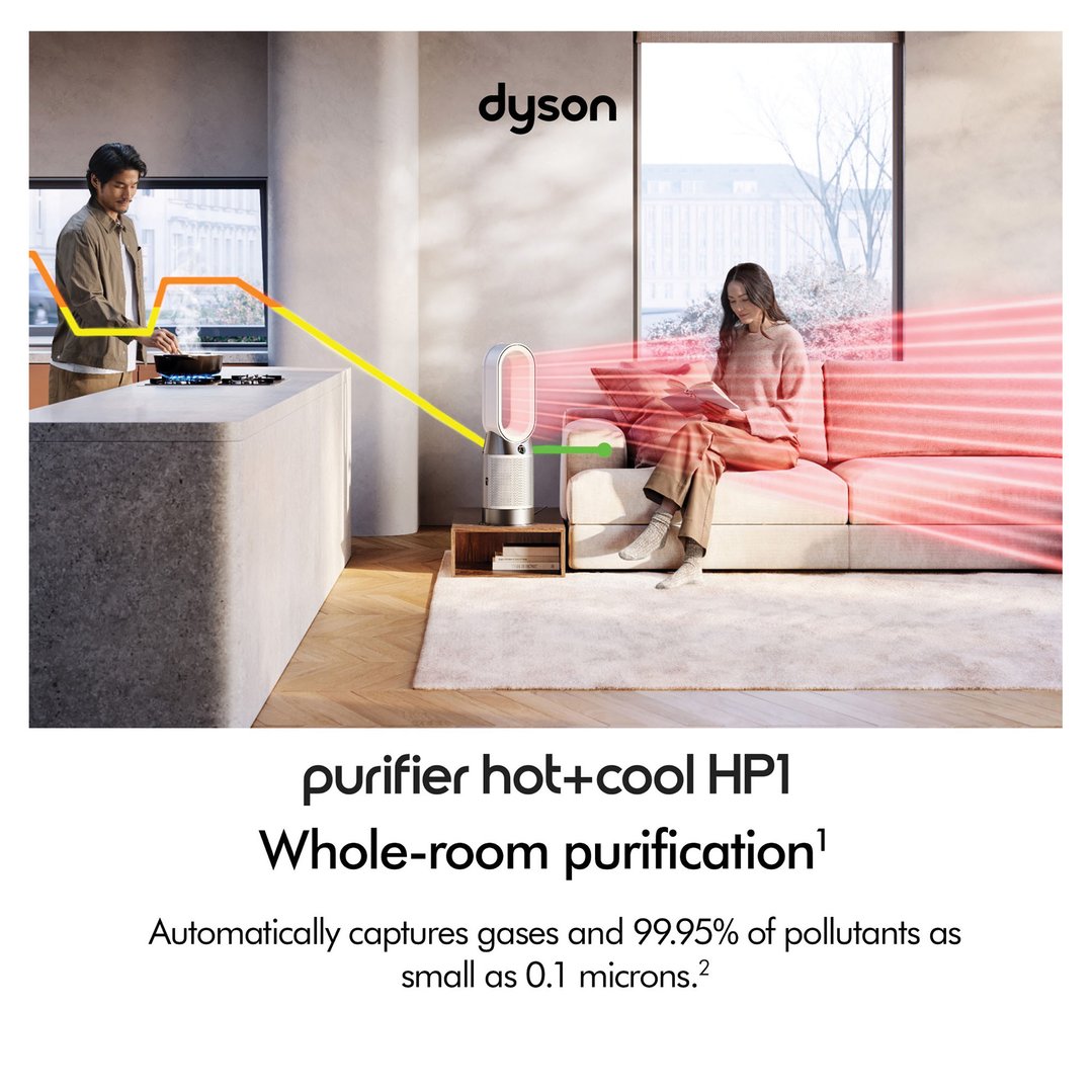 Man cooking in kitchen, woman reading on sofa with Dyson air purifier