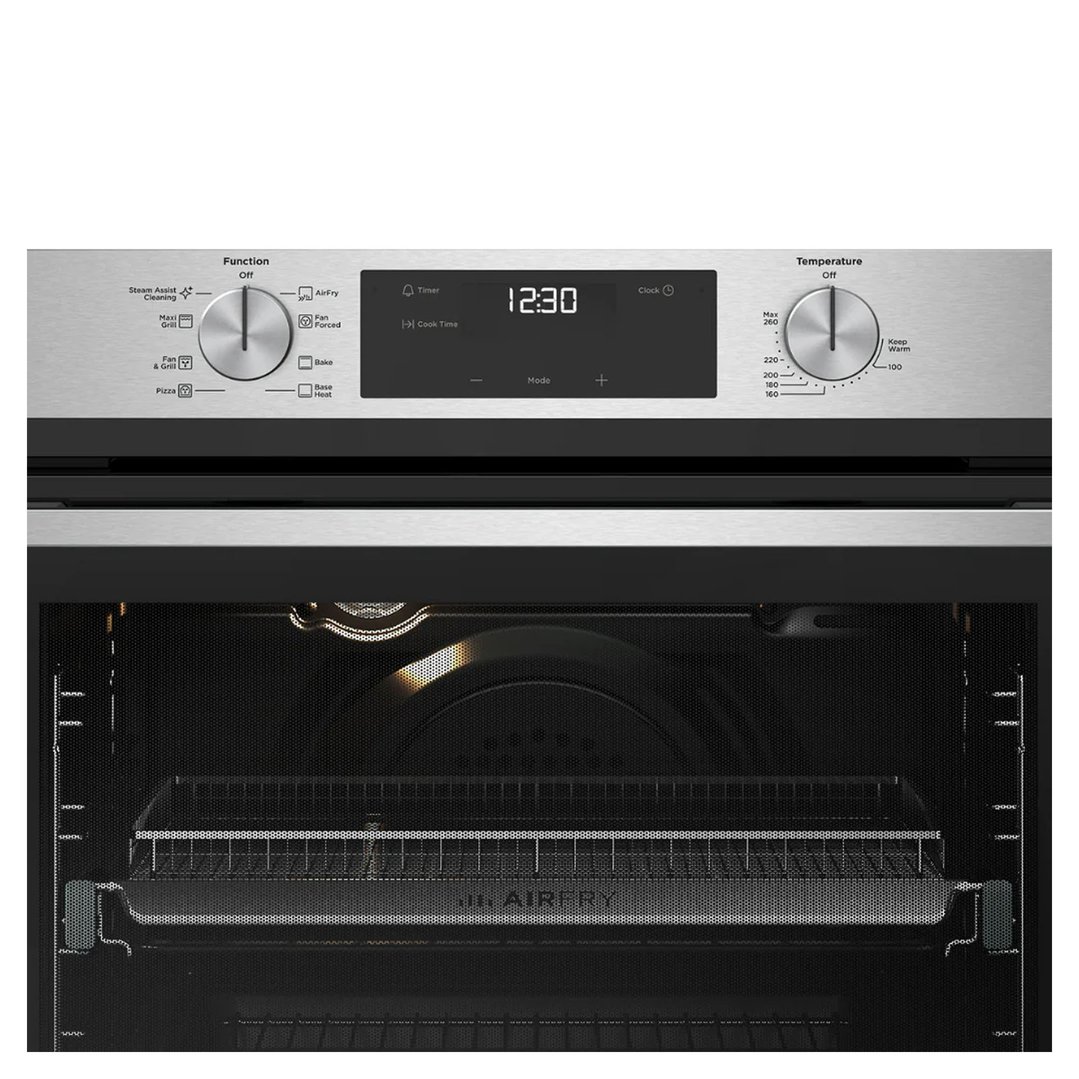 Close up of an oven with its door open, showing the interior and controls