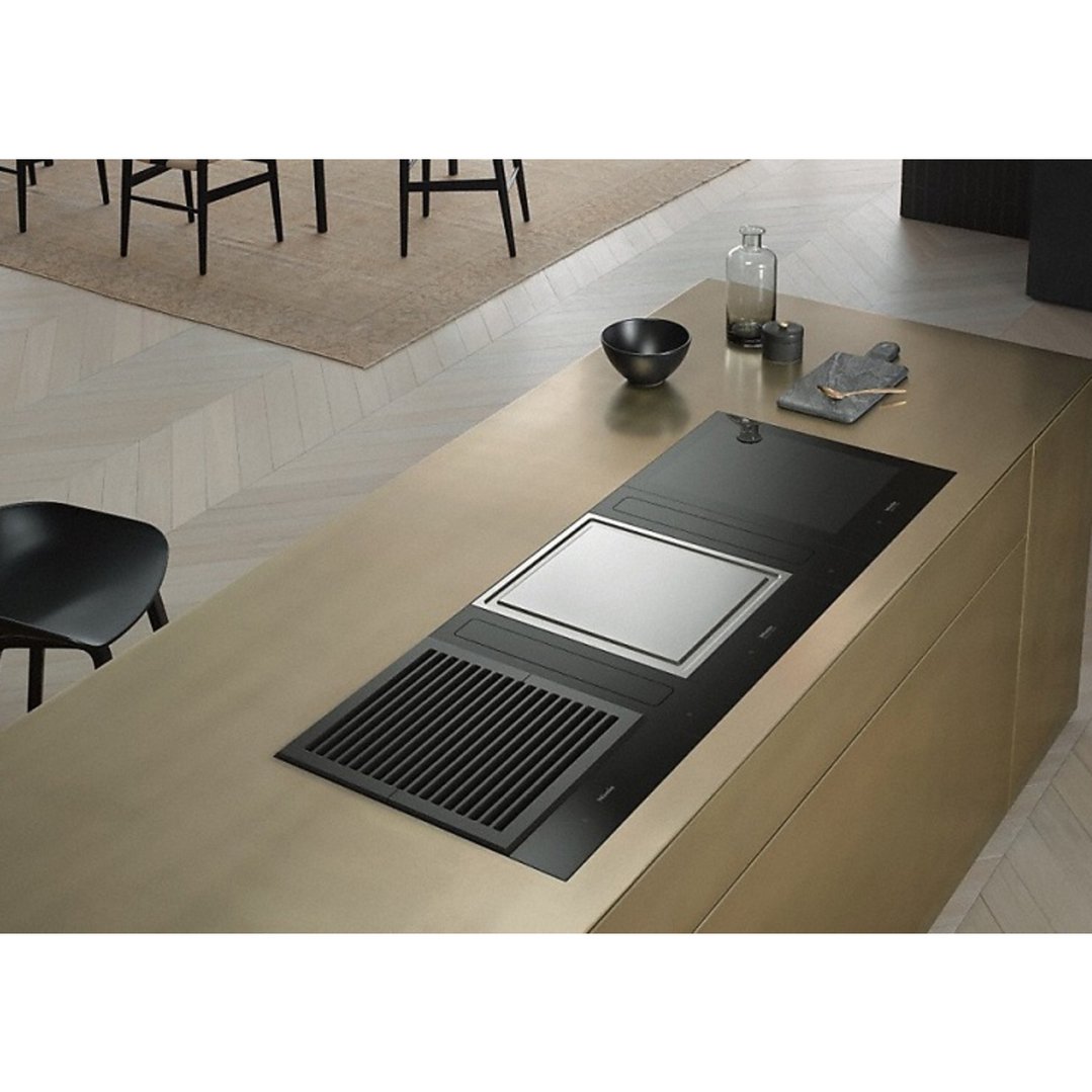 Teppanyaki cooktop and induction combi set built into a gold kitchen island