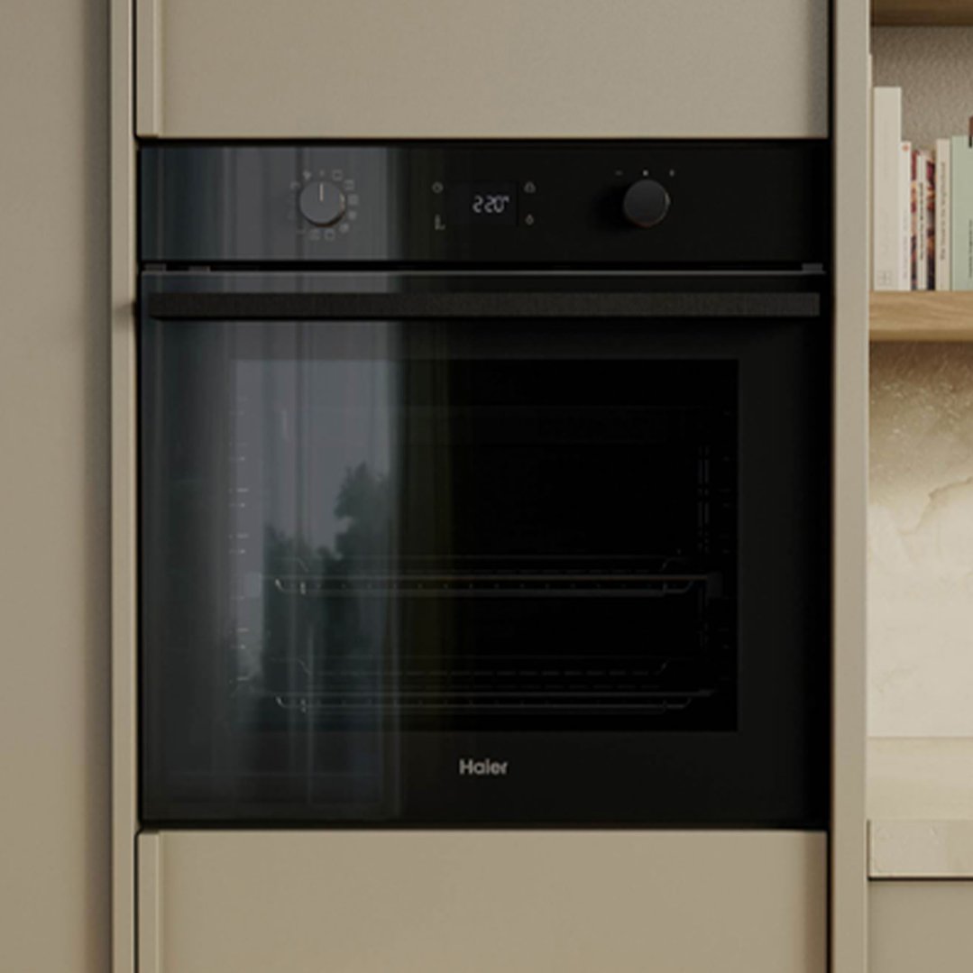 Built-in oven with black glass door and control panel in a kitchen setting