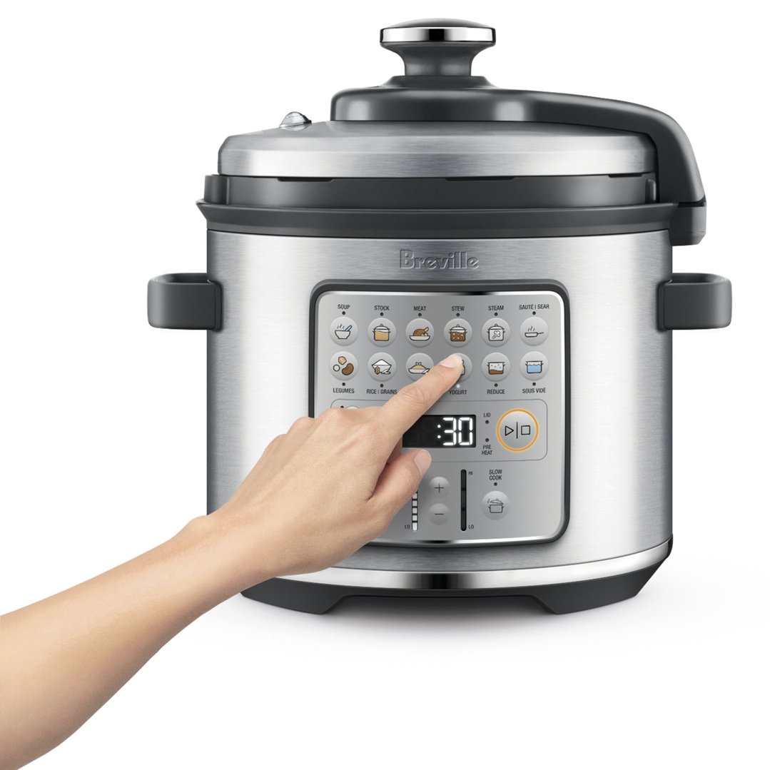 Hand pressing a button on the control panel of a Breville Fast Slow GO™ Pressure Cooker