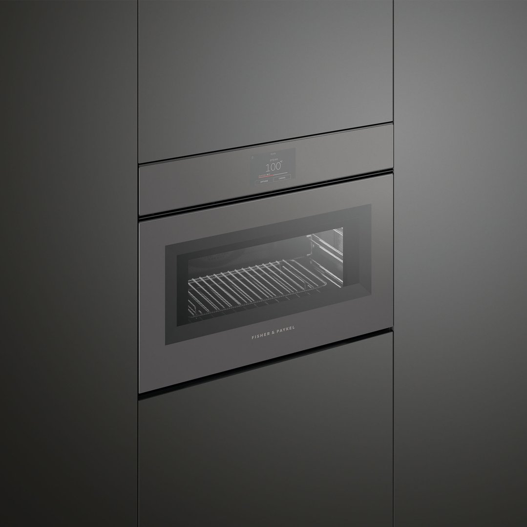 A built-in Fisher & Paykel microwave oven with a digital display in a dark kitchen