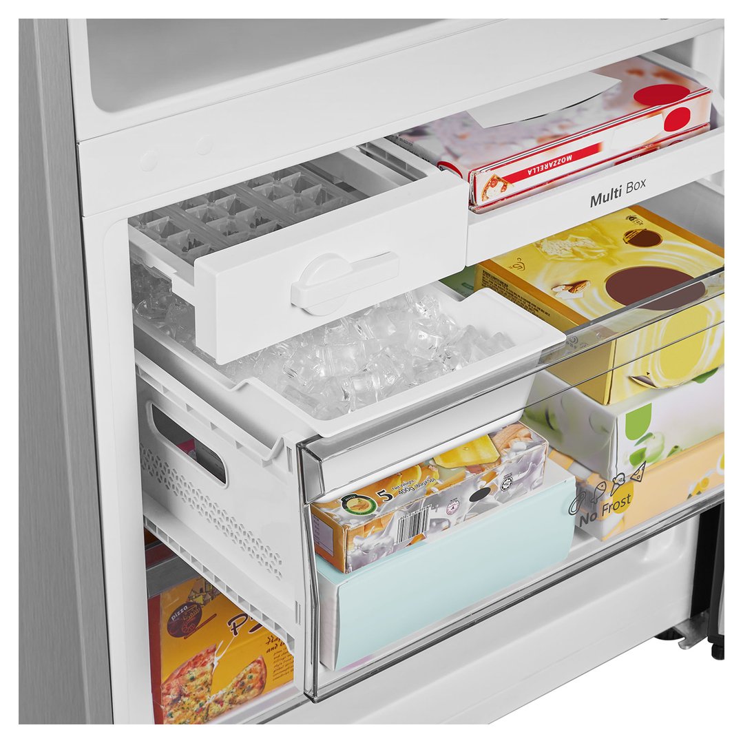 Open freezer compartment of a bottom mount fridge with ice and frozen food