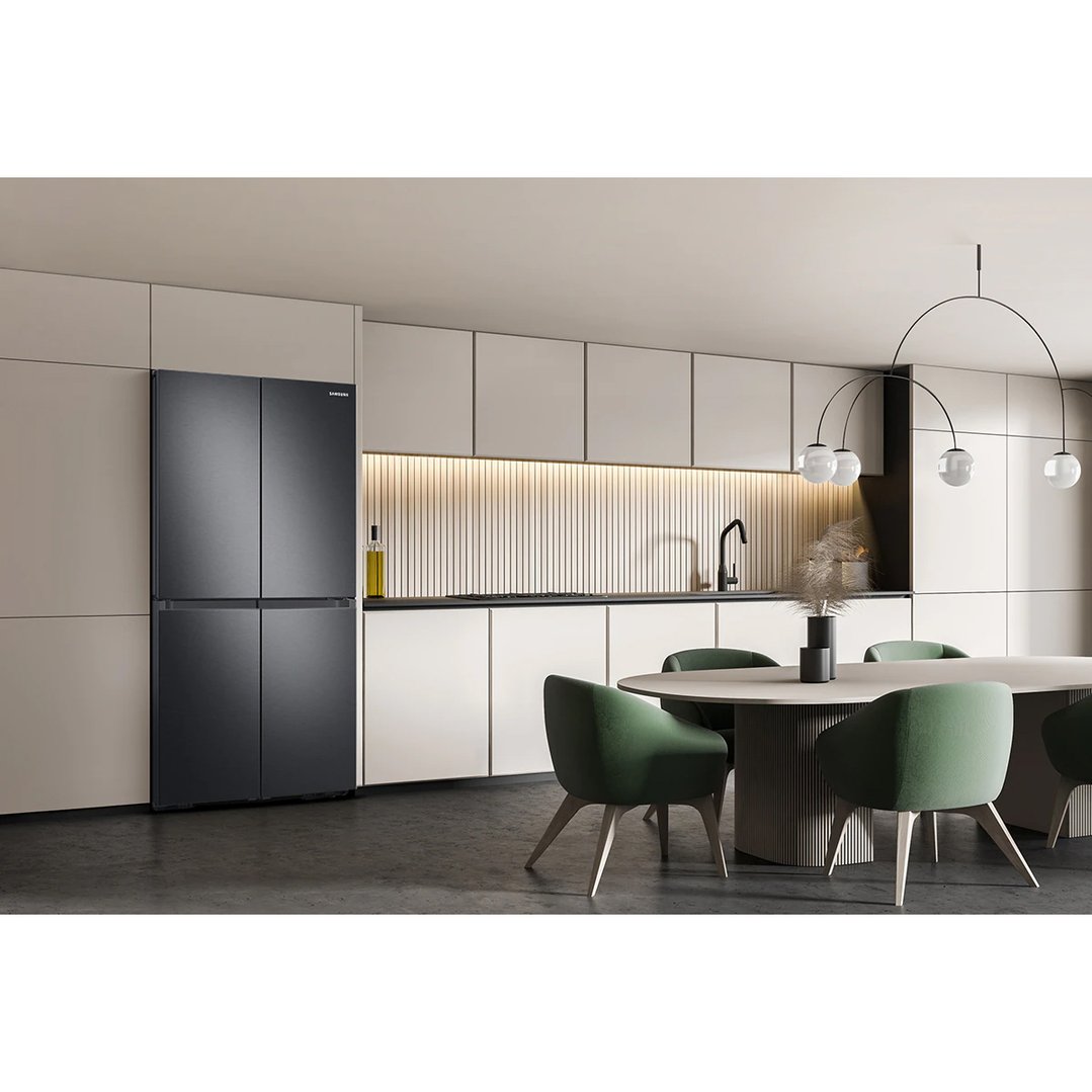 Black French door fridge in a modern kitchen with a dining area